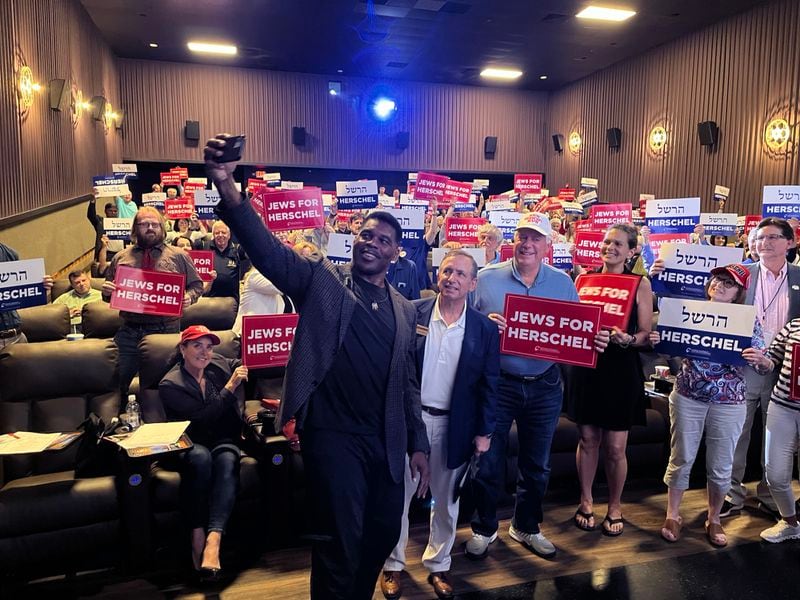 Republican Senate hopeful Herschel Walker takes a selfie at a Republican Jewish Coalition event on Aug. 21, 2022 in Sandy Springs. 
