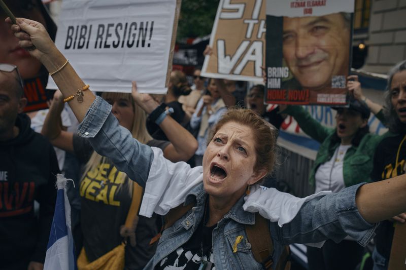 People protest against Prime Minister of Israel Benjamin Netanyahu during the 79th session of the United Nations General Assembly, in New York, on Friday, Sept. 27, 2024. (AP Photo/Andres Kudacki)