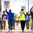 Longshoremen walk the picket line at the Barbours Cut Container Terminal during the first day of a dockworkers strike on Tuesday, Oct. 1, 2024, in Houston. (AP Photo/Annie Mulligan)