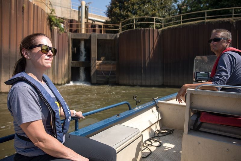 Candace Baumann (left) and Jason Ulseth (right) with the Chattahoochee Riverkeepers survey locations on the river where the city of Atlanta discharges treated sewer water during a boat patrol ride on June 14, 2024. Riley Bunch / riley.bunch@ajc.com