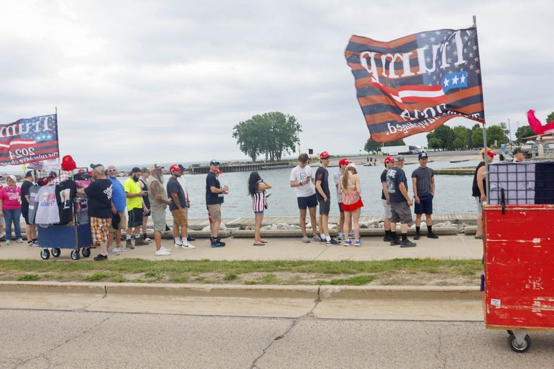 People wait in line to enter the venue where Republican presidential candidate former President Donald Trump will speak at a campaign event Tuesday, June 18, 2024, in Racine, Wis. (AP Photo/Jeffrey Phelps)