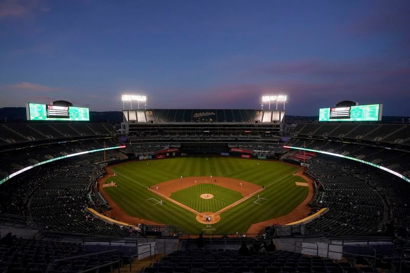 FILE - Fans at Oakland Coliseum watch a baseball game between the Oakland Athletics and the Cincinnati Reds in Oakland, Calif., on April 28, 2023. (AP Photo/Jeff Chiu, File)