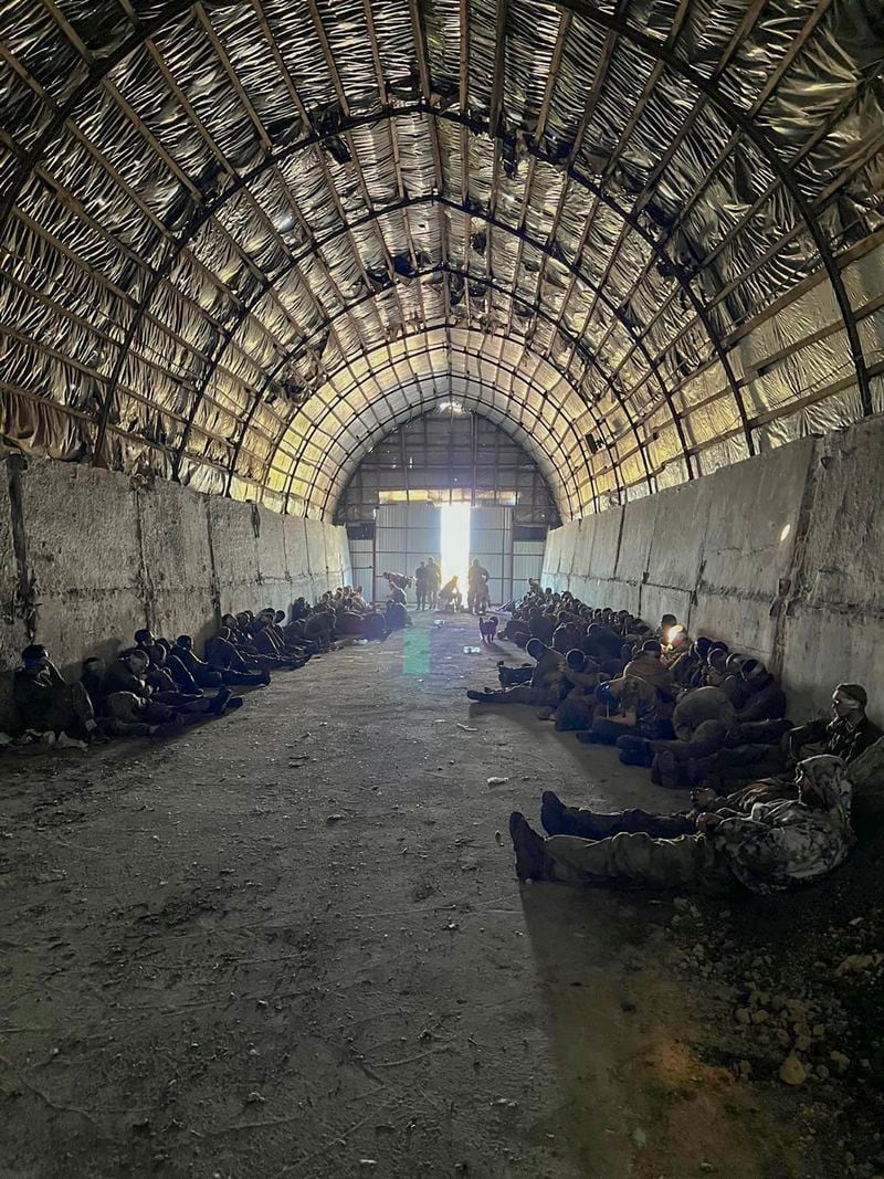 In this photo provided by the Ukrainian Security Service Press Office, over 100 Russian prisoners of war captured by a Security Service special unit during one military action are seen in a shelter in Kursk region, Russia, Wednesday, Aug. 14, 2024. (Ukrainian Security Service Press Office via AP)