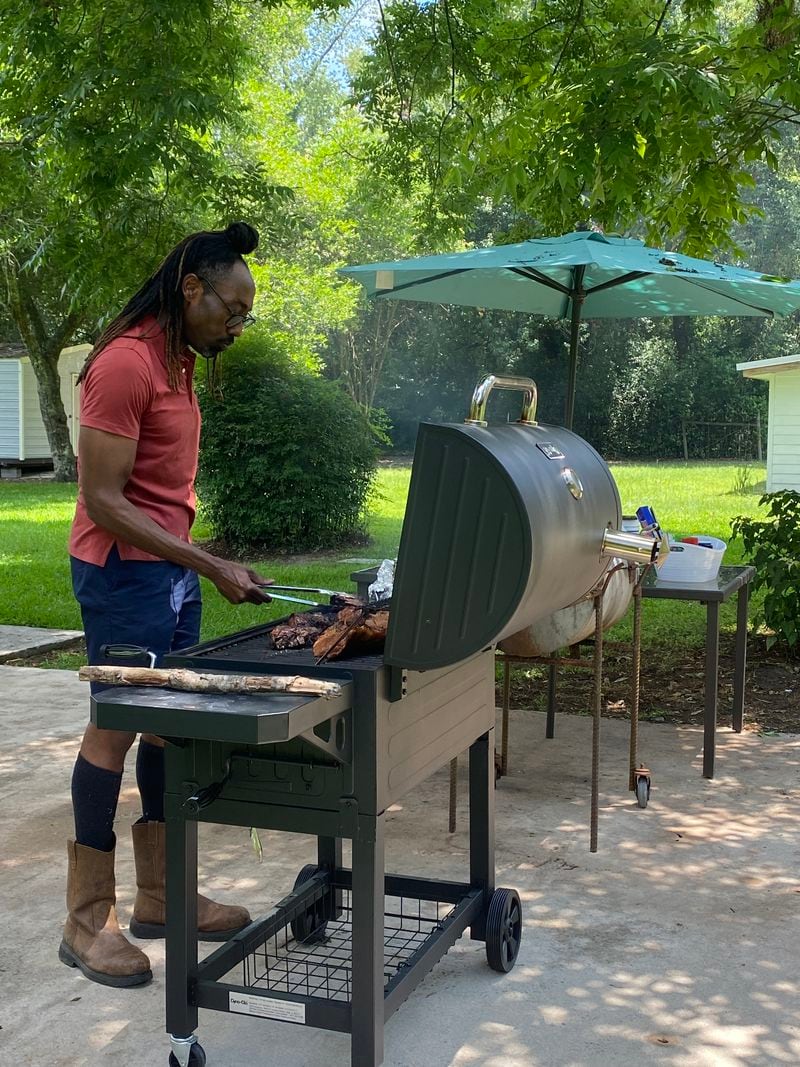 Clinton Vicks grills jerk chicken at a "Taste of the South" dining experience he hosts at his home in Albany as part of the new Southwest Georgia Agri-Tourism Trail. Ligaya Figueras / ligaya.figueras@ajc.com