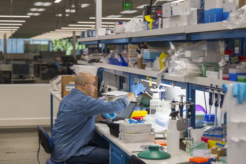 A lab technician prepares DNA samples for analysis at Complete Genomics in San Jose, Calif., Monday, July 22, 2024. (AP Photo/Nic Coury)