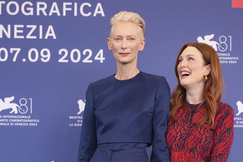 Tilda Swinton, left, and Julianne Moore pose for photographers at the photo call for the film 'The Room Next Door' during the 81st edition of the Venice Film Festival in Venice, Italy, on Monday, Sept. 2, 2024. (Photo by Vianney Le Caer/Invision/AP)