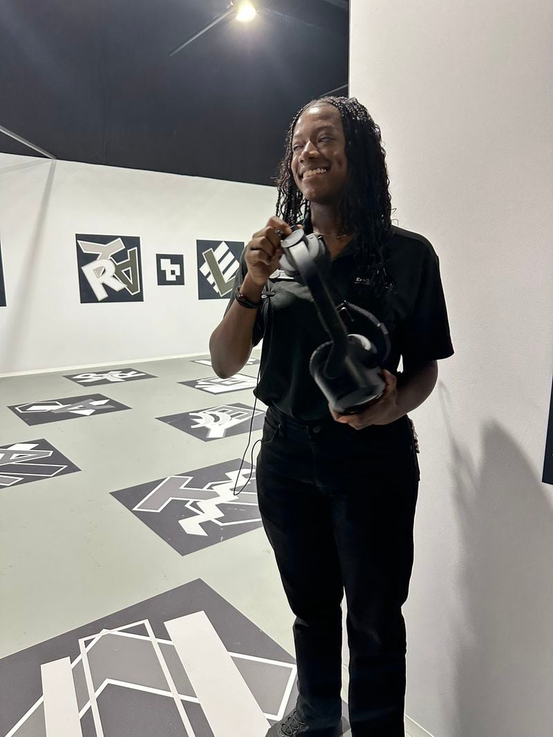 A bonus virtual reality experience at "Titanic: An Immersive Voyage" in Atlanta that takes about 10 to 15 minutes is available. It enables you to see the ruins of the ship as it looks now, then walk through parts of the ship as if it were 1912. Ayana Daniels, a guest service assistant, holds one of the VR headsets. RODNEY HO/rho@ajc.com