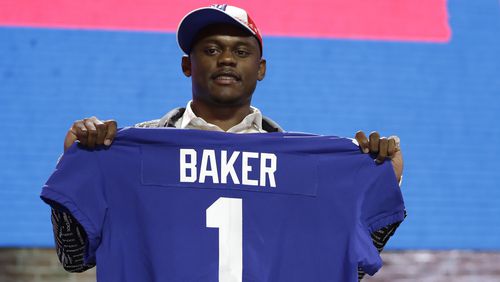 Georgia defensive back DeAndre Baker poses with his new jersey after the New York Giants selected him in the first round at the NFL football draft April 25, 2019, in Nashville, Tenn.