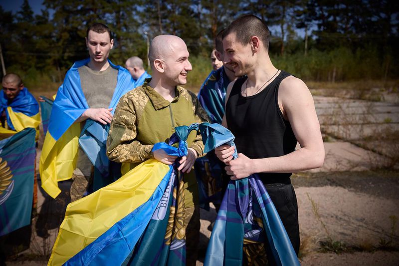 Ukrainians react after being released in a prisoner exchange at an undisclosed location in Ukraine, Saturday Sept. 14, 2024. (Ukrainian Presidential Press Office via AP)