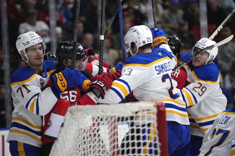 Players scuffle during the NHL hockey game between Buffalo Sabres and New Jersey Devils, in Prague, Czech Republic, Saturday, Oct. 5, 2024. (AP Photo/Petr David Josek)