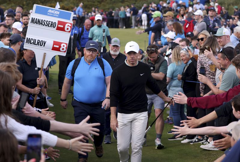 Northern Ireland's Rory McIlroy walks between lines of fans as he makes his way to the thirteenth tee during day four of the Amgen Irish Open 2024 at Royal County Down in Newcastle, County Down, England, Sunday Sept. 15, 2024. (Peter Morrison/PA via AP)