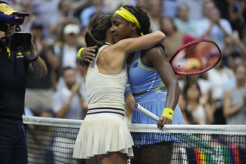 Emma Navarro, left, of the United States, embraces Coco Gauff, of the United States, after defeating her in the fourth round of the U.S. Open tennis championships, Sunday, Sept. 1, in New York. 2024. (AP Photo/Pamela Smith)