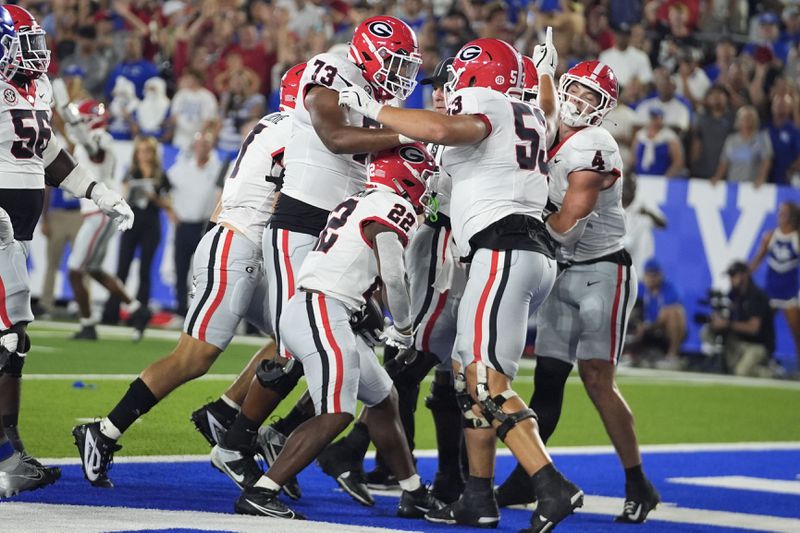 Georgia running back Branson Robinson (22) celebrates a touchdown with his teammates during the second half of an NCAA college football game against Kentucky, Saturday, Sept. 14, 2024, in Lexington, Ky. (AP Photo/Darron Cummings)