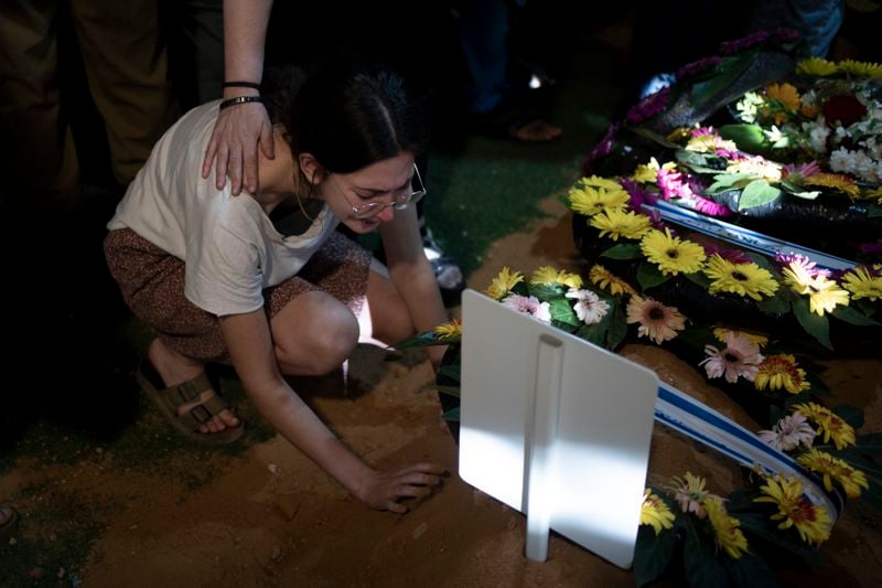 A relative weeps at the grave of Israeli Army Capt. Eitan Yitzhak Oster, who was killed in action in Lebanon, during his funeral at Mt. Herzl military cemetery in Jerusalem, Wednesday, Oct. 2, 2024. (AP Photo/Maya Alleruzzo)