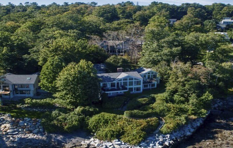 This undated image provided by Vinal Applebee shows the home of Lisa Gorman in the foreground, the poisoned oak trees behind her home, and the home of the perpetrators behind the dead trees, in Camden, Maine. (Vinal Applebee via AP)