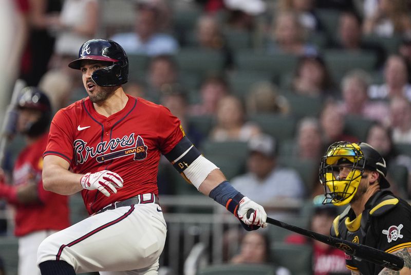 Atlanta Braves' Adam Duvall drives in a run with a double as Pittsburgh Pirates catcher Yasmani Grandal (6) looks on in third inning of a baseball game Friday, June 28, 2024, in Atlanta. (AP Photo/John Bazemore)