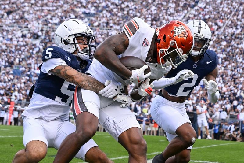 Bowling Green wide receiver Malcolm Johnson Jr. (1) is tackled by Penn State cornerback Cam Miller (5) during the first quarter of an NCAA college football game, Saturday, Sept. 7, 2024, in State College, Pa. (AP Photo/Barry Reeger)