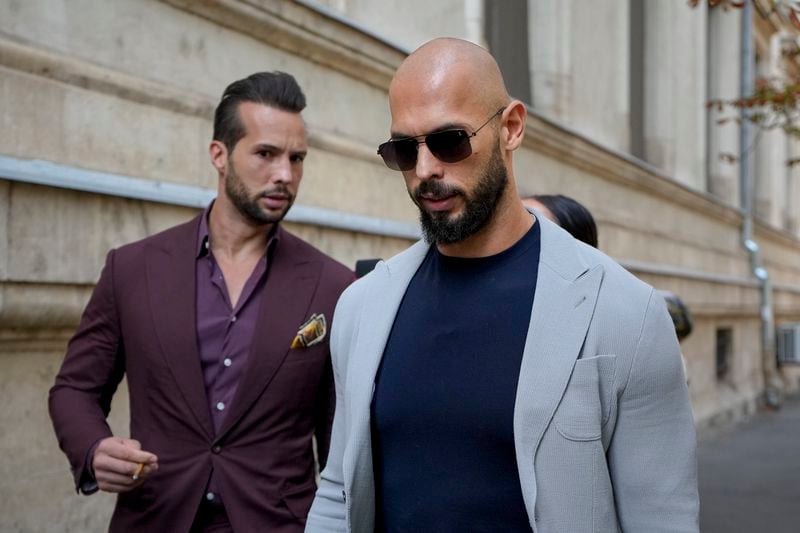 Andrew Tate and his brother Tristan, left, walk outside the Court of Appeals building, after a hearing, in Bucharest, Romania, Wednesday, Sept. 4, 2024. (AP Photo/Vadim Ghirda)