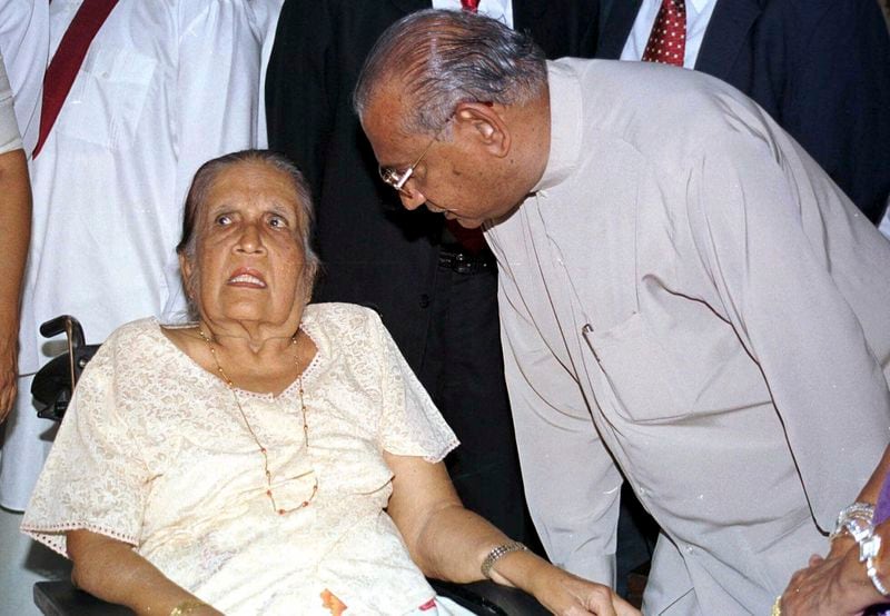 FILE - Sirimavo Bandaranaike, left, thrice Sri Lanka's prime minister, talks with her successor Ratnasiri Wickramanayake after he was sworn in, in Colombo, Sri Lanka, Aug. 10, 2000. (AP Photo, File)