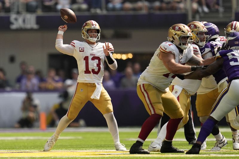 San Francisco 49ers quarterback Brock Purdy (13) fumbles the ball during the second half of an NFL football game against the Minnesota Vikings, Sunday, Sept. 15, 2024, in Minneapolis. (AP Photo/Abbie Parr)