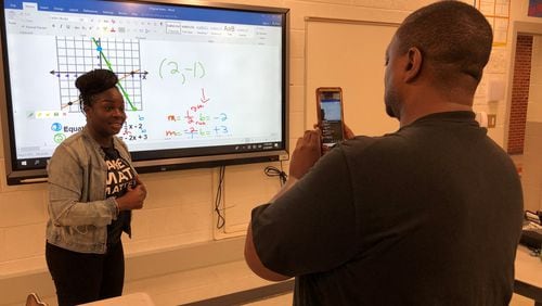 North Clayton Middle School eighth-grade math teachers Alisha Rosser and Carlos Johnson offer online instruction to students of the school Monday. The district, like most across metro Atlanta, closed schools indefinitely as the nation grapples with the coronavirus outbreak.