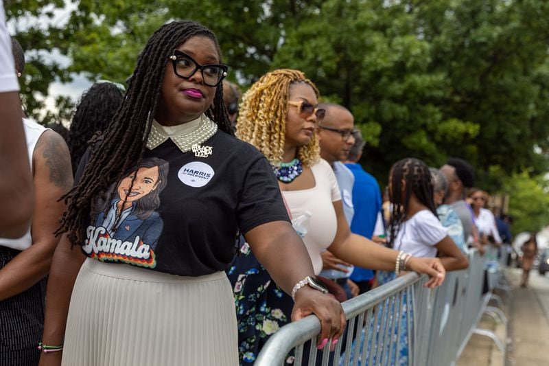 Tiffanie Morris, left, waits outside the Georgia State University Convocation Center in Atlanta on Tuesday before a campaign rally for Kamala Harris. A line stretched for blocks ahead of the evening event. (Arvin Temkar / AJC)