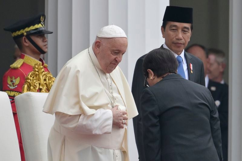 Pope Francis, center left, meets Indonesia's Foreign Minister Retno Marsudi, foreground, as Indonesia's President Joko Widodo, center right, looks on during a ceremonial welcome at the Presidential Palace in Jakarta Wednesday, Sept. 4, 2024. (Bay Ismoyo/Pool Photo via AP)