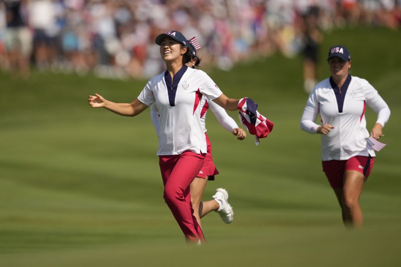 United States players celebrate after winning the Solheim Cup golf tournament at the Robert Trent Jones Golf Club, Sunday, Sept. 15, 2024, in Gainesville, Va. (AP Photo/Matt York)