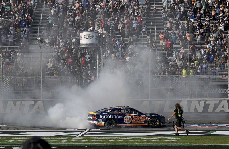 Joey Logano (22) celebrates with a burnout after winning a NASCAR Cup Series auto race at Atlanta Motor Speedway, Sunday, Sept. 8, 2024, in Hampton, Ga. (Hyosub Shin/Atlanta Journal-Constitution via AP)