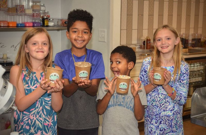 Proud new chefs (from left) Harper Wright, 9, Gionne Robinson, 10, Jacadi Robinson, 8, and Alden Wright, 9 show off their just-made Edible Sugar Cookie Dough. Gionne and Jacadi are White’s sons. CONTRIBUTED BY CHRIS HUNT PHOTOGRAPHY