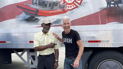 Artist Kevin Kresse, who sculpted a statue of Johnny Cash destined for the U.S. Capitol, laughs with Shimpfort Hardney, who will be driving the sculpture to Washington, outside the Arkansas Capitol in Little Rock, Ark., Thursday, Sept. 5, 2024. (AP Photo/Andrew DeMillo)