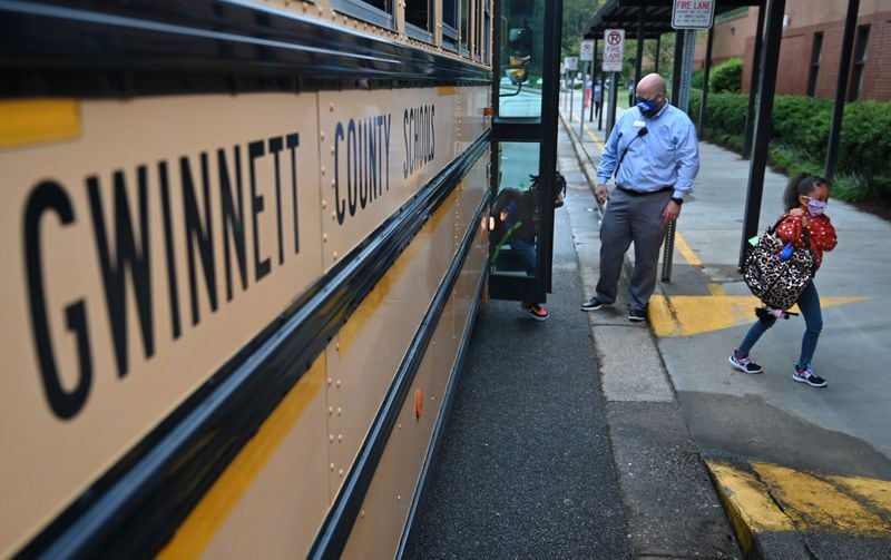Students wearing masks arrive to Jackson Elementary School in Gwinnett County in this August 26, 2020 file photo. Vaccinating teachers in Gwinnett County, Georgia's largest school district, will not be a quick process, school officials said. (Hyosub Shin / Hyosub.Shin@ajc.com)