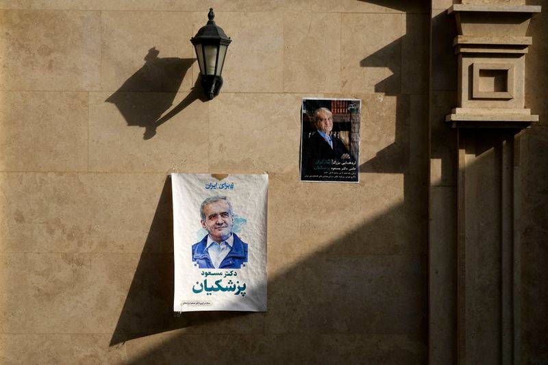 Posters of reformist candidate for the Iranian presidential election Masoud Pezeshkian are pasted on the wall at his campaign headquarters, in Tehran, Iran, Saturday, June 29, 2024. Iran will hold a runoff presidential election to replace the late hard-line President Ebrahim Raisi after an initial vote saw the top candidates not secure an outright win in the lowest turnout poll ever held in the Islamic Republic by percentage. (AP Photo/Vahid Salemi)