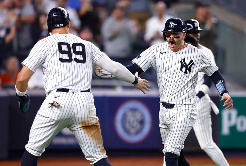 New York Yankees' Aaron Judge (99) and Austin Wells, front right, celebrate after scoring against the Baltimore Orioles during the sixth inning of a baseball game, Thursday, Sept. 26, 2024, in New York. (AP Photo/Noah K. Murray)