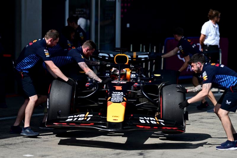 Red Bull mechanics handle the car of Max Verstappen, of the Netherlands, on the pit lane, during the qualifying for the Austrian Formula One Grand Prix at the Red Bull Ring racetrack in Spielberg, southern Austria, Saturday, June 29, 2024. (Christian Bruna, Pool)