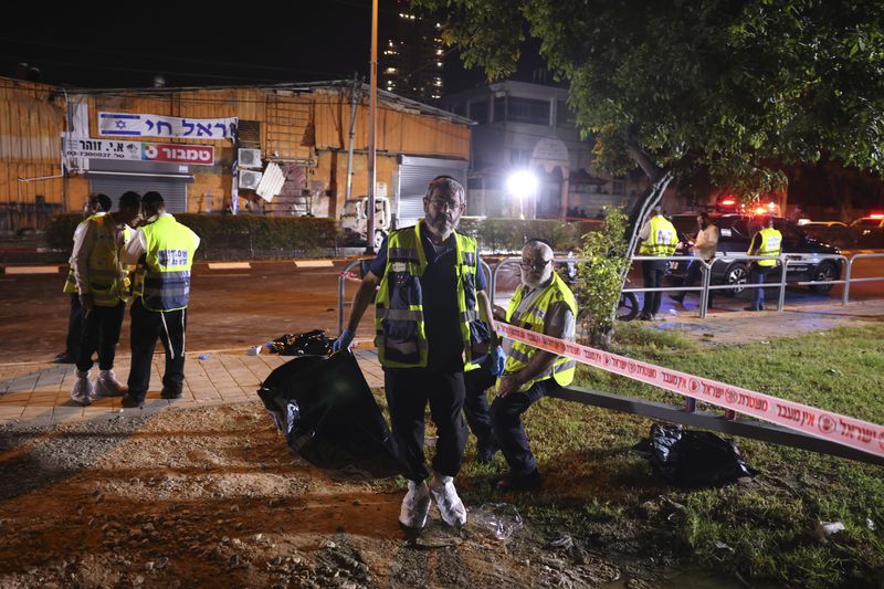 An Israeli ZAKA volunteer works at the scene of a bomb explosion in Tel Aviv, Israel, Sunday, Aug. 18, 2024. Israeli Police say one person was killed and another moderately injured. (AP Photo/Moti Milrod)