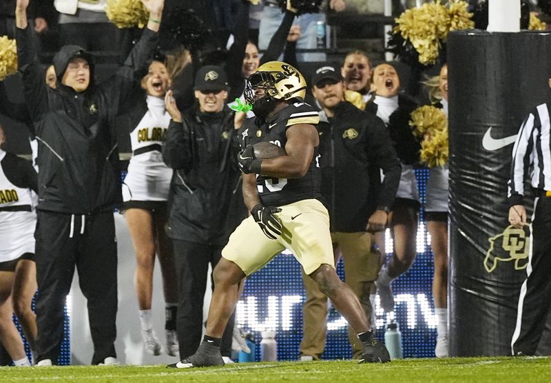 Colorado running back Isaiah Augustave scores a touchdown in overtime of an NCAA college football game against Baylor, Saturday, Sept. 21, 2024, in Boulder, Colo. (AP Photo/David Zalubowski)