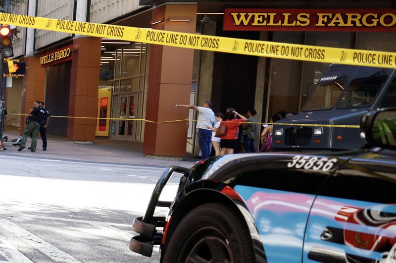 Joseph Grier can be seen pointing at the scene of a shooting at the Peachtree Center in downtown.