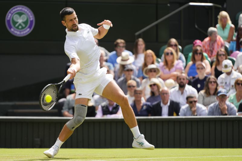 Serbia's Novak Djokovic plays a forehand return to Britain's Jacob Fearnley during their second round match at the Wimbledon tennis championships in London, Thursday, July 4, 2024. (AP Photo/Kirsty Wigglesworth)