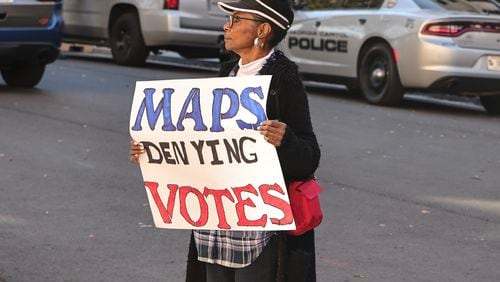 Brenda Owens holds a sign that reads ‘Maps denying Votes’ in opposition to new proposed Congressional district maps outside of the Georgia State Capitol on  Tuesday, Dec. 5, 2023. The Georgia chapter of the NAACP on Wednesday urged U.S. District Judge Steve Jones to reject the maps. (Natrice Miller/Natrice.miller@ajc.com)