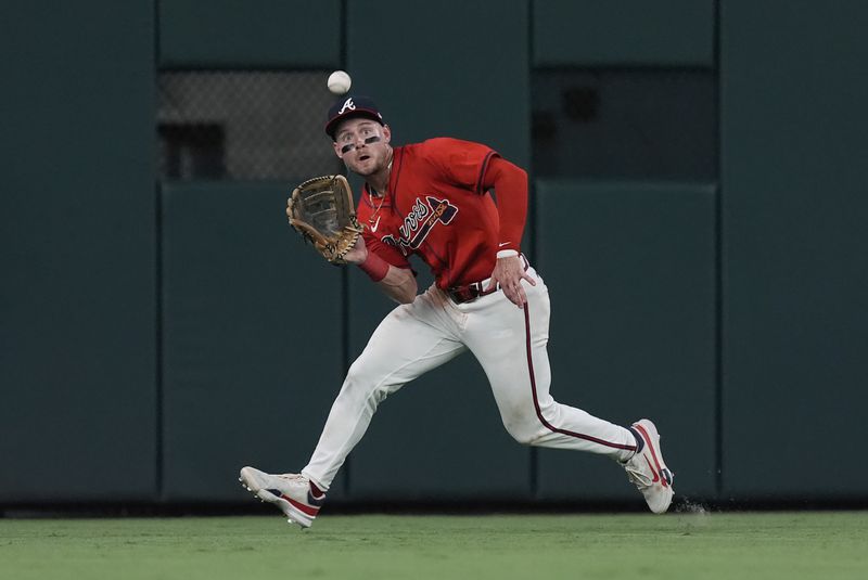 Atlanta Braves centerfielder Jarred Kelenic catches a flyball off the bat of Pittsburgh Pirates' Edward Olivares in the sev enth inning of a baseball game Friday, June 28, 2024, in Atlanta. (AP Photo/John Bazemore)