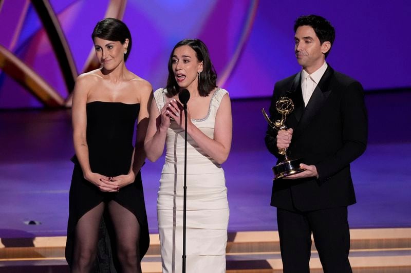 Jen Statsky, from left, Lucia Aniello, and Paul W. Downs accept the award for outstanding writing for a comedy series for "Hacks" during the 76th Primetime Emmy Awards on Sunday, Sept. 15, 2024, at the Peacock Theater in Los Angeles. (AP Photo/Chris Pizzello)