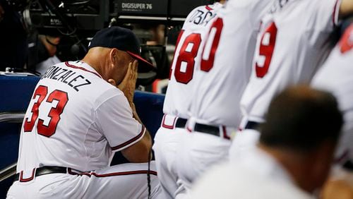 Atlanta Braves manager Fredi Gonzalez hangs his head in the dugout in the ninth inning of a game against the San Francisco Giants on Tuesday, Aug. 4, 2015, in Atlanta. (AP Photo/David Goldman)