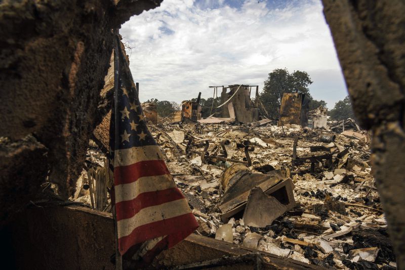 The remains of a structure destroyed by the Apache Fire as it burns in Palermo, Calif., on Tuesday, Jun. 25, 2024.According to Cal Fire, more than a dozen new fires sparked by lightning. (AP Photo/Ethan Swope)
