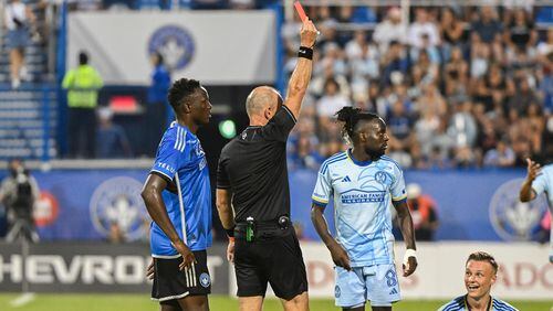 Atlanta United's Stian Gregersen, right, reacts after being shown the red card by the referee, second from left, during second-half MLS soccer match action against CF Montreal in Montreal, Saturday, July 13, 2024. (Graham Hughes/The Canadian Press via AP)