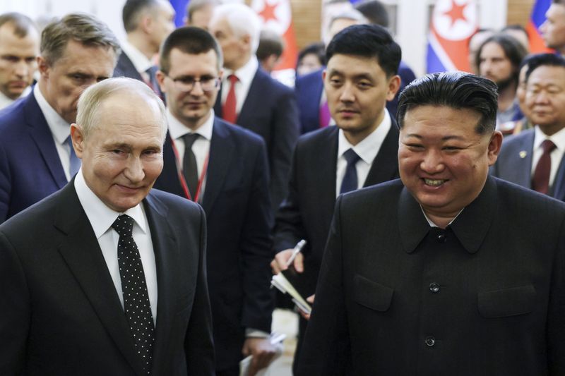 Russian President Vladimir Putin, left, and North Korea's leader Kim Jong Un smile as they walk after the talks in Pyongyang, North Korea, on Wednesday, June 19, 2024. (Gavriil Grigorov, Sputnik, Kremlin Pool Photo via AP)