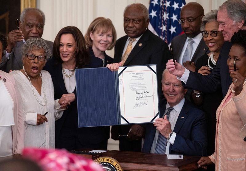 Vice President Kamala Harris, front, second from left, and Opal Lee, front left, the activist known as the grandmother of Juneteenth, watch as President Joe Biden holds the signed Juneteenth National Independence Day Act in the East Room of the White House in 2021.