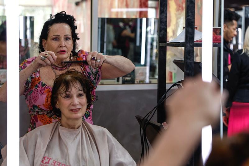 Three-13 Salon, Spa & Boutique partner Marian Crowell trims Vivian Kirby’s hair on Wednesday, March 13, 2024. (Natrice Miller/ Natrice.miller@ajc.com)