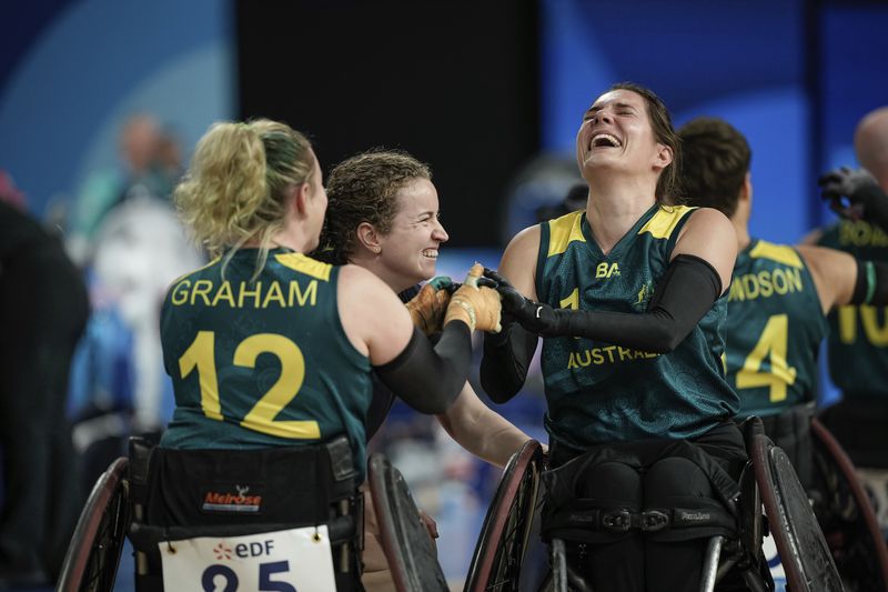 Australia's Ella Sabljak and Australia's Shae Graham, left, celebrate after winning the match during the wheelchair rugby bronze medal match between Australia and Great Britain at the 2024 Paralympics, Monday, Sept. 2, 2024, in Paris, France. (AP Photo/Aurelien Morissard)