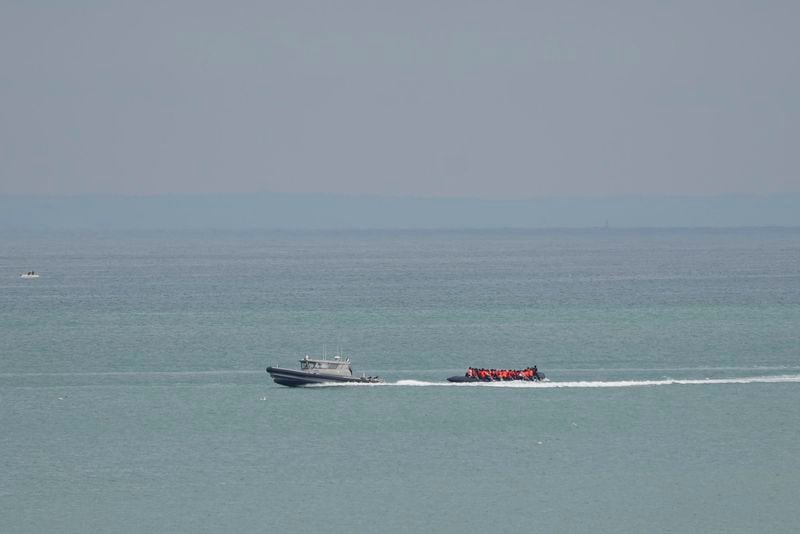 A boat thought to be with migrants is escorted by a vessel from the French Gendarmerie Nationale off the Wimereux beach, France, Wednesday, Sept. 4, 2024. Another boat carrying several dozen people is making another attempt to cross the English Channel from northern France just a day after 12 migrants died. (AP Photo/Nicolas Garriga)